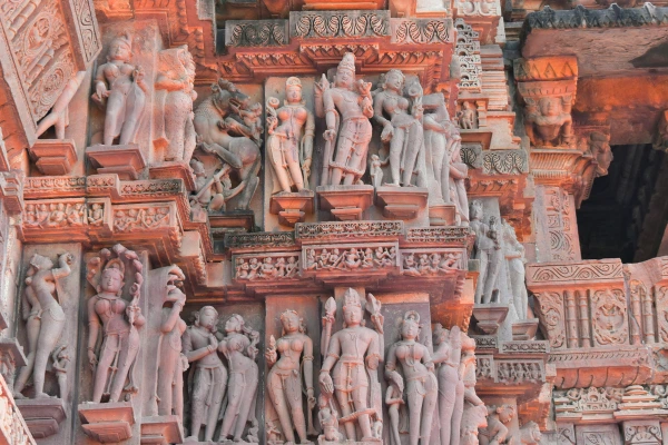 Intricate stone carvings at Khajuraho temple, showcasing ancient Indian art and mythology.