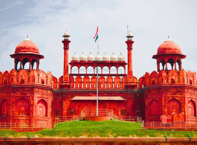Red Fort in Delhi with Indian flag flying atop the historic Mughal-era sandstone fort
