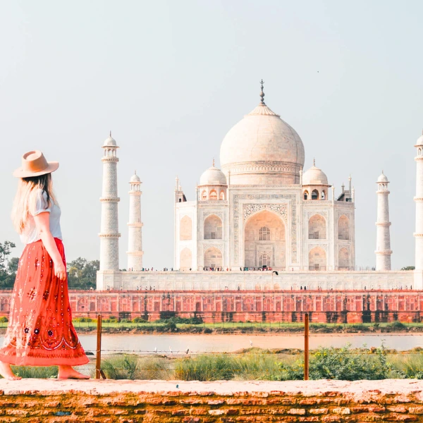 Female tourist admiring the Taj Mahal in Agra, India during a sunny day